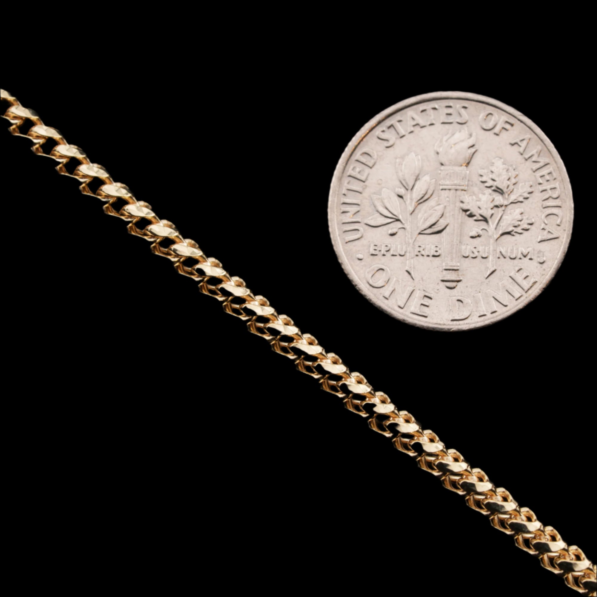2.5mm diamond-cut franco solid gold chain next to a dime for size comparison