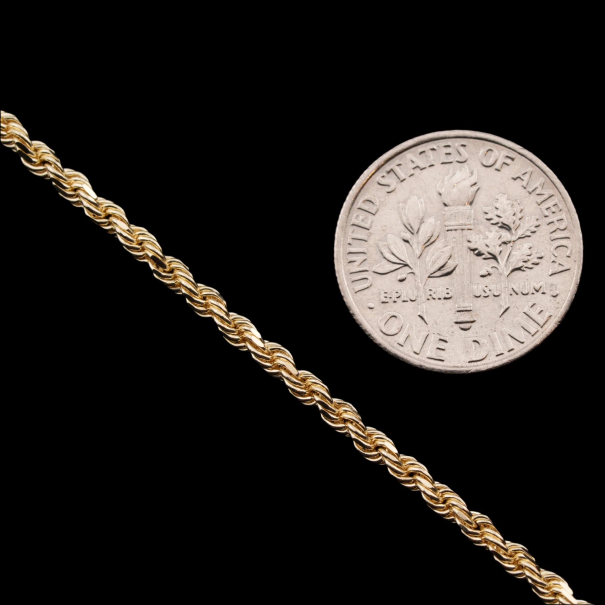 2.5mm diamond-cut rope solid gold chain next to a dime for size comparison